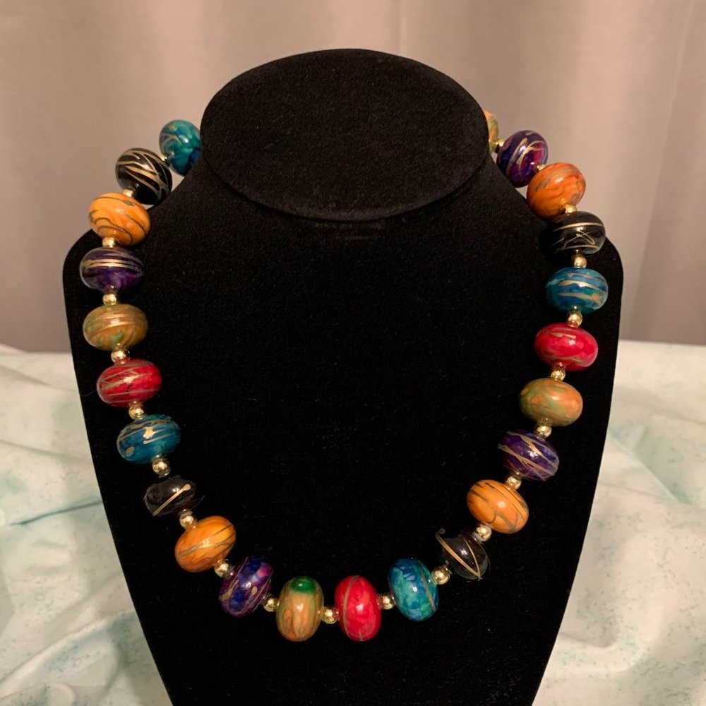 Multi-colored large bead necklace with gold embellishments.  17 Inch continuous.